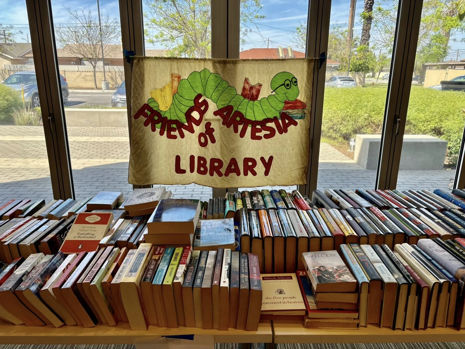 Books beneath the Friends of Artesia Library banner at our April 2025 book sale