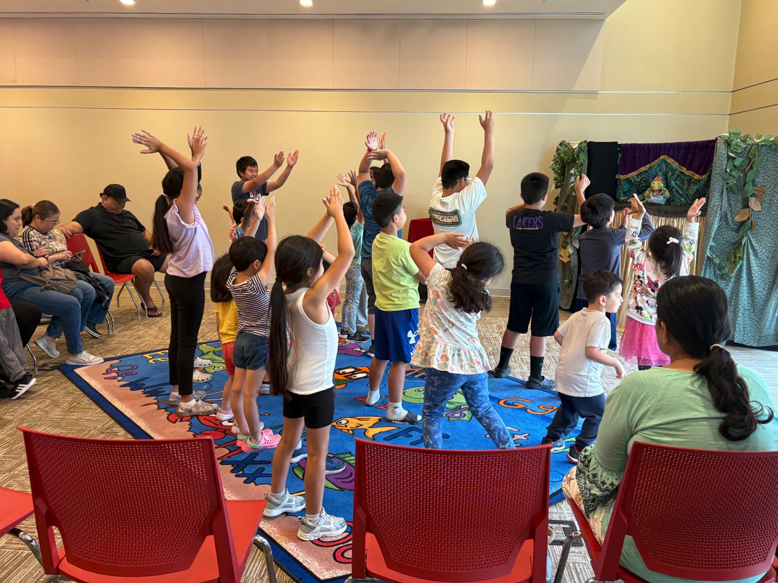 Children joining in the Dinosaur Puppet Magic Show at Artesia Library